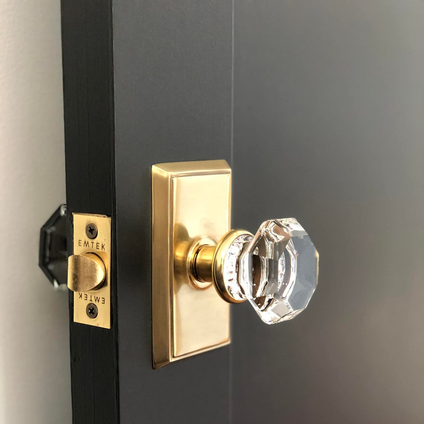 Crystal door handle on a black door.