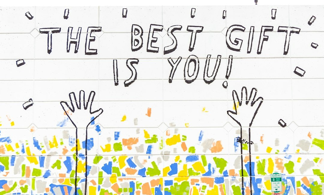 woman walking beside wall with the best gift is you graffiti woman walking beside wall with the best gift is you graffiti