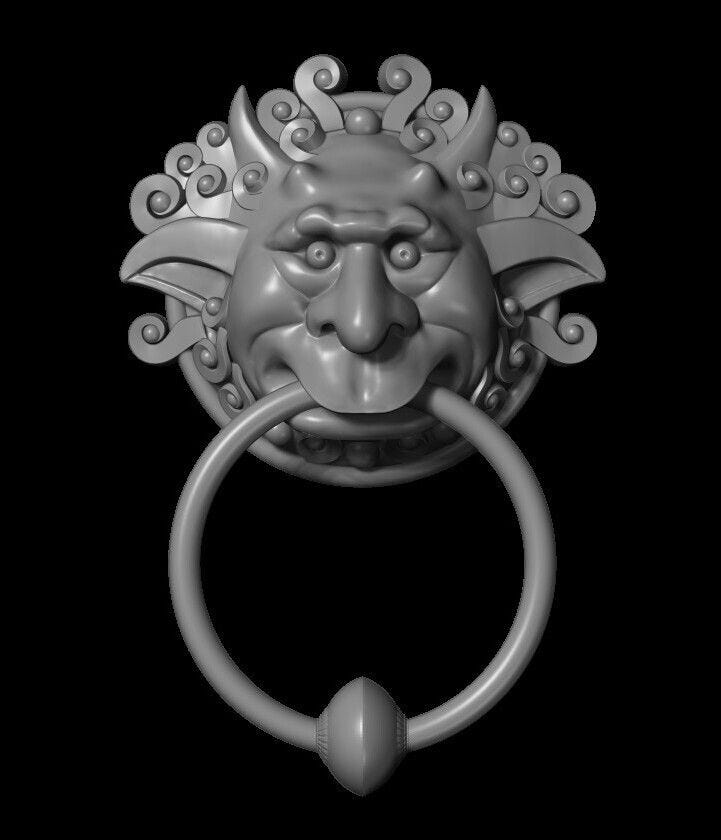 This may contain: a metal ring with a lion head on it's face and an oval handle