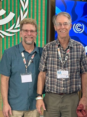 Two men standing next to each other

AI-generated content may be incorrect.