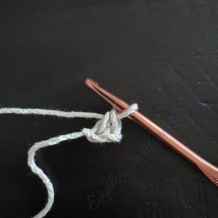 A crochet hook with a thread

Description automatically generated