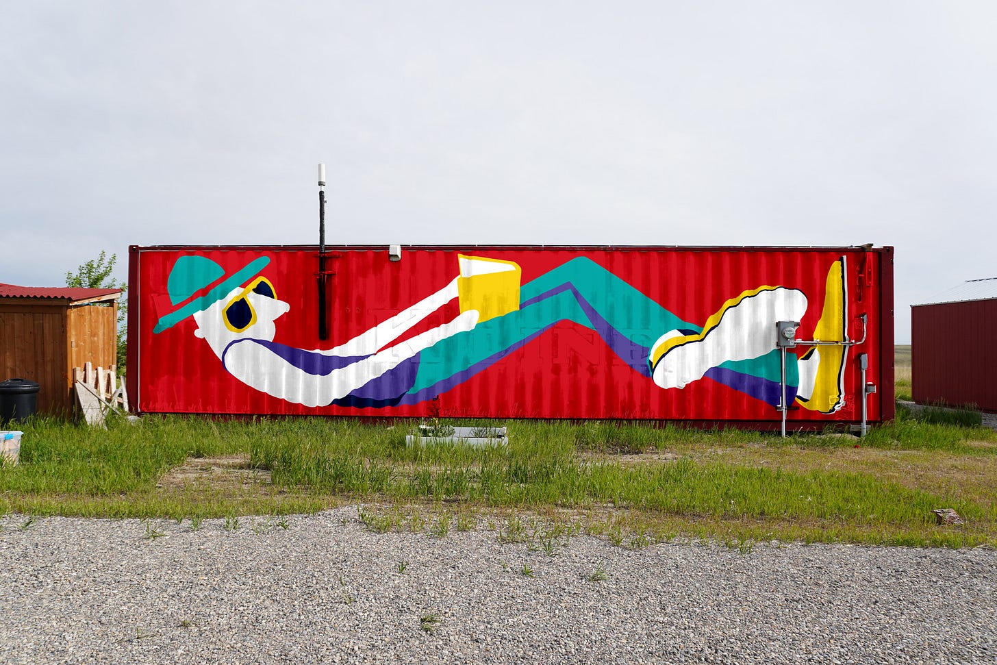 Mockup of The Reader illustration onto the surface of a 40 foot wide shipping container in the middle of a farm field.