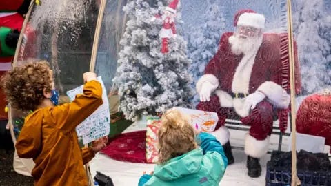 Plexiglass, sanitiser and masks: US mall Santas prepare for Christmas