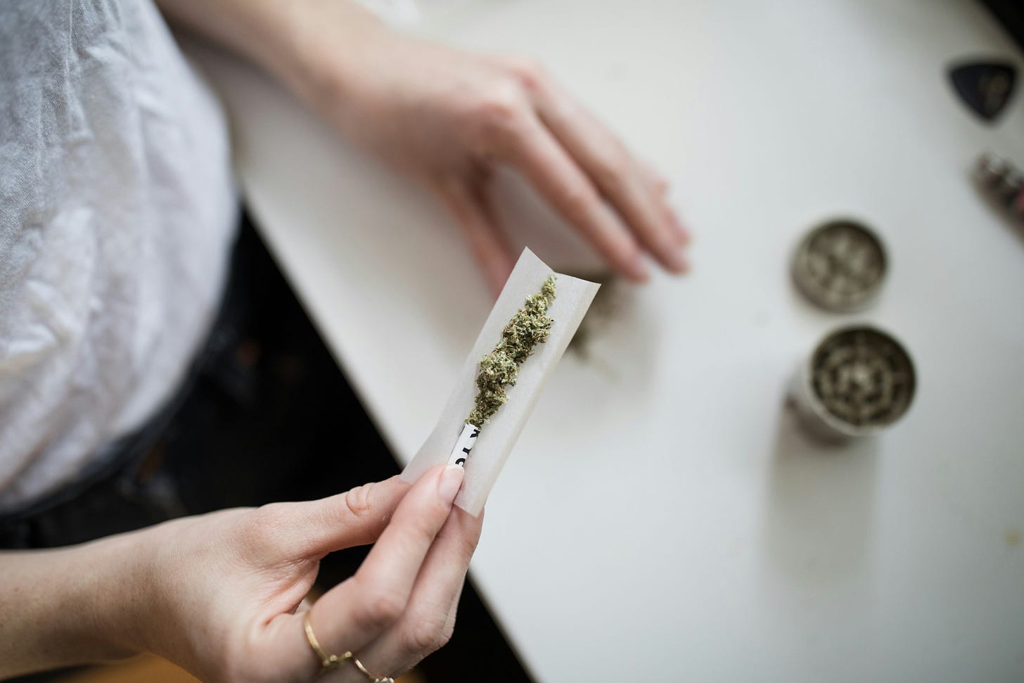 person rolling cannabis joint
