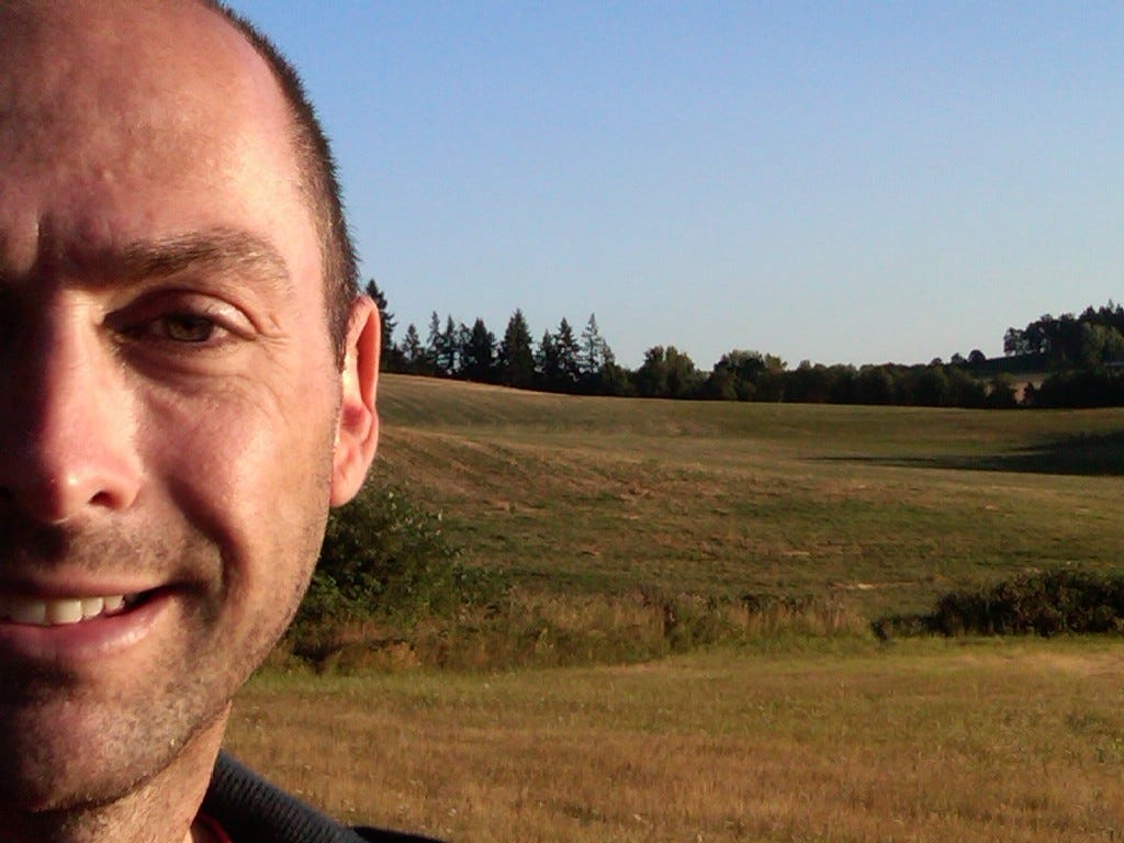 Mark with deep rolling hills in background