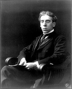Black-and-white photo of Zangwill wearing a suit, tie, and glasses Black-and-white photo of Zangwill wearing a suit, tie, and glasses