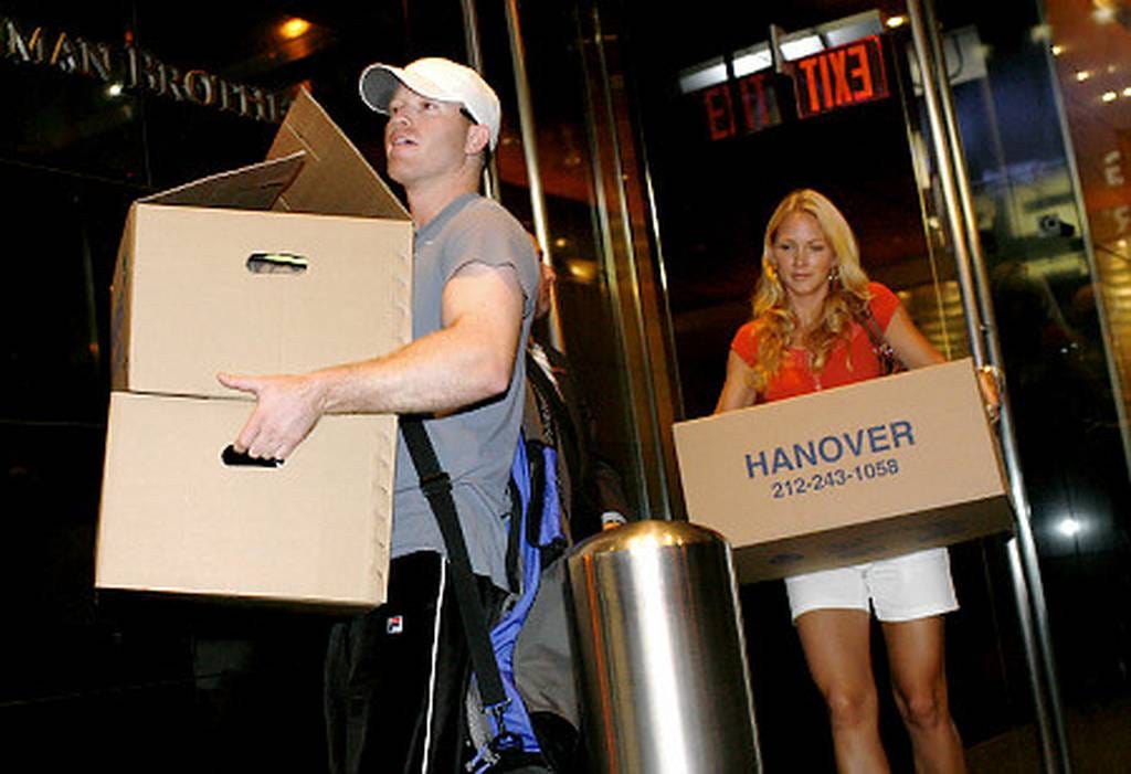 Lehman employees carrying out boxes of personal items Sunday night after learning the firm was declaring bankruptcy.