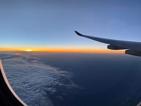 California landscape with hills and a blue sky, family photo in a gondola above Lisbon, view out the airplane window of the sunset
