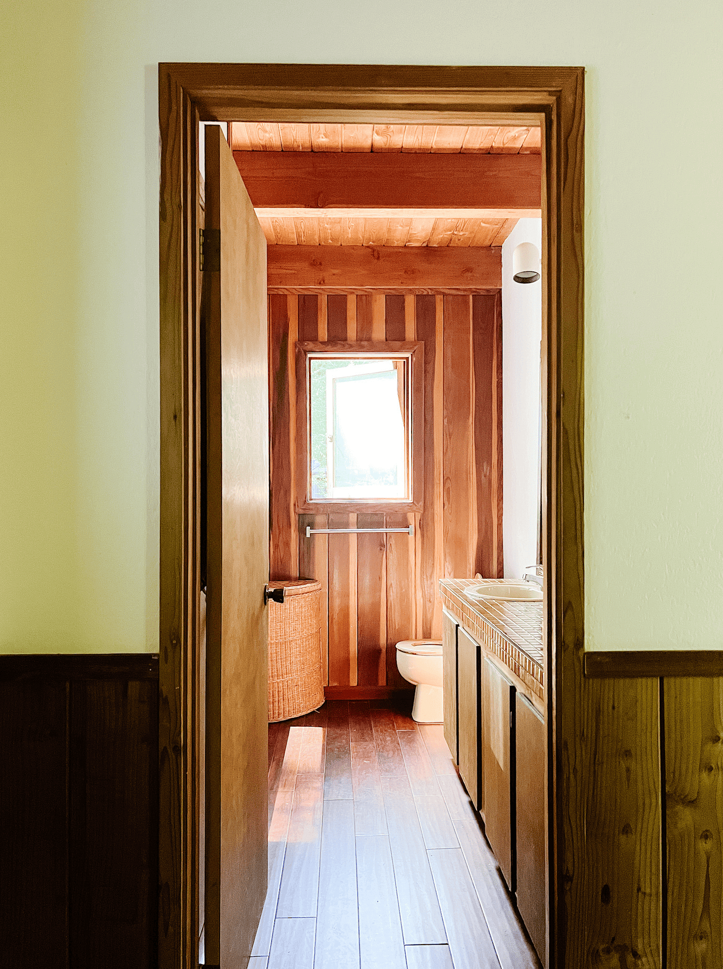 Before the demo of the cabin looking through a wood framed floor with orignial builder grade floors and decaying features. 