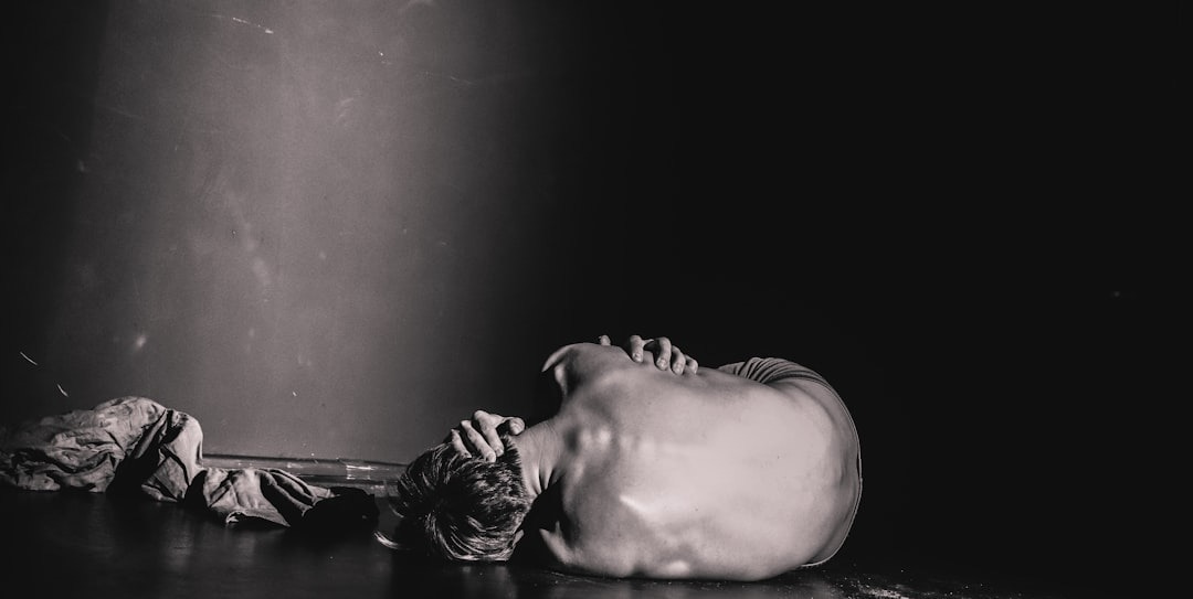 grayscale photography of man lying on floor grayscale photography of man lying on floor