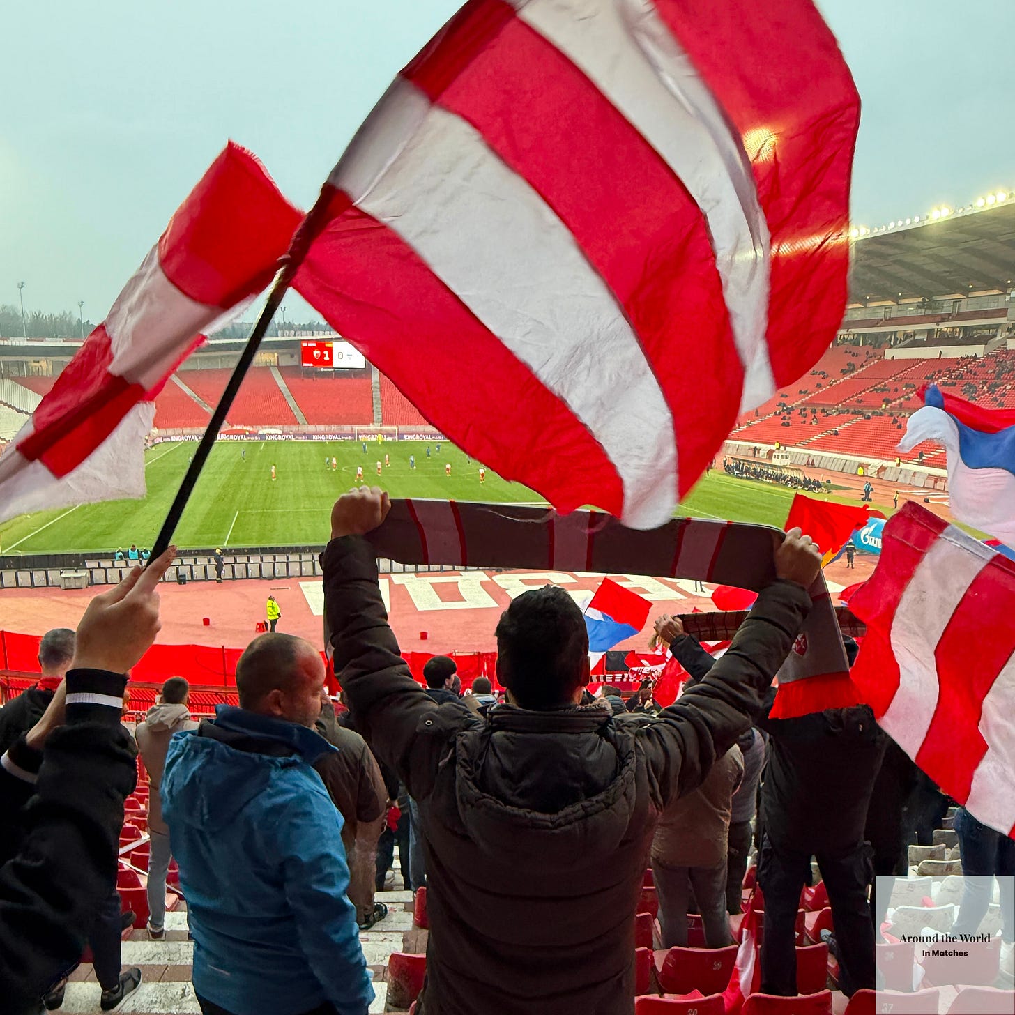 Fans wave flags and hold their scarves aloft after Red Star go up 1-0.