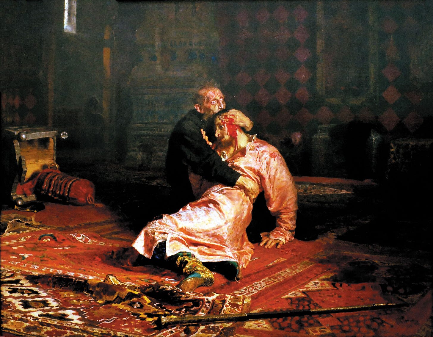 An old man in a black robe kneels on a red carpet and clutches a young man in a pink coat against his chest. A staff lies on the floor in front of them. An old man in a black robe kneels on a red carpet and clutches a young man in a pink coat against his chest. A staff lies on the floor in front of them.