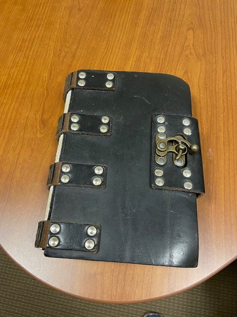 A leather-bound journal on a desk.