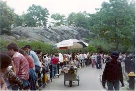 A crowd of people walking on a sidewalk

Description automatically generated