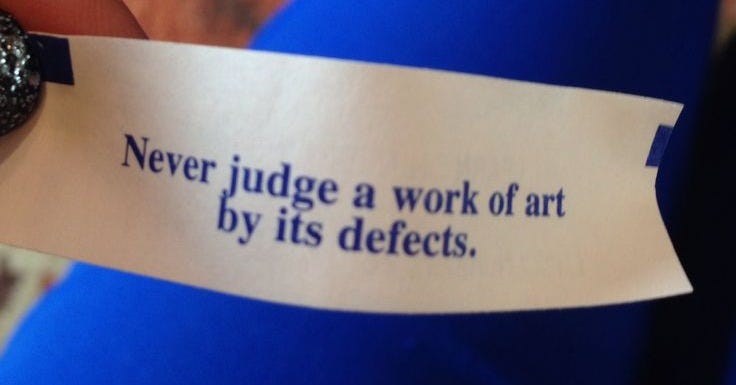 This may contain: someone is holding up a piece of paper that says never judge a work of art by its defects This may contain: someone is holding up a piece of paper that says never judge a work of art by its defects