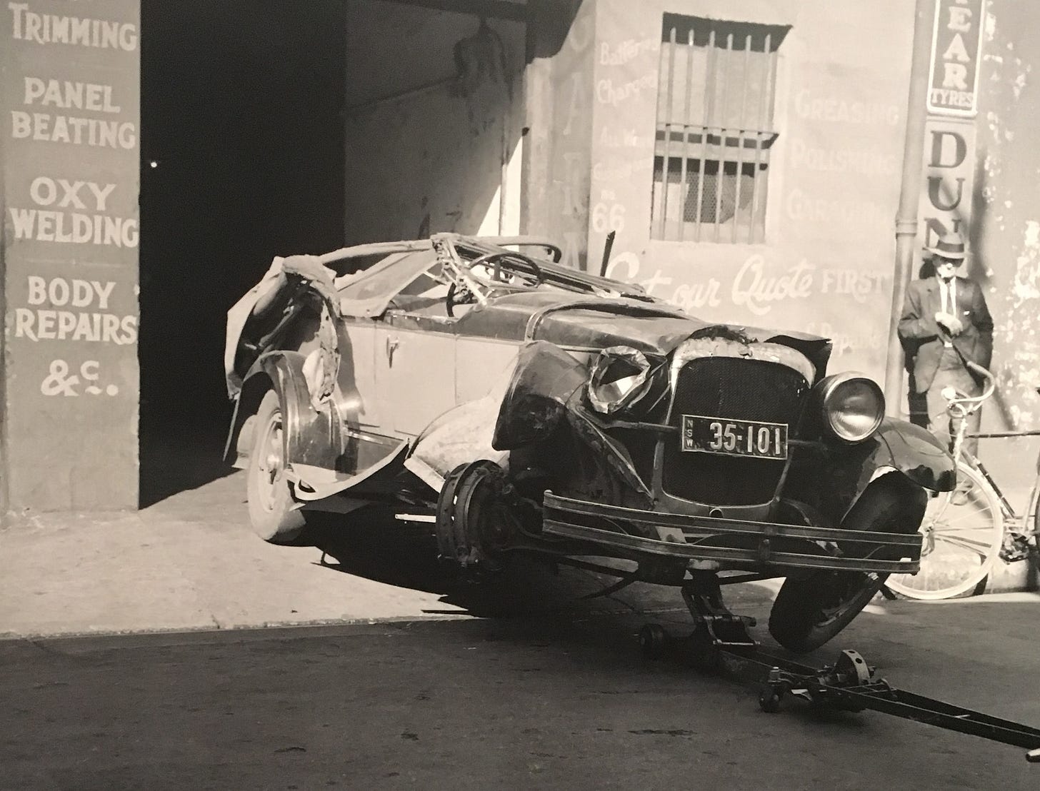 Damaged motorcar at a panelbeater's garage. Photographer and location unknown, c1936