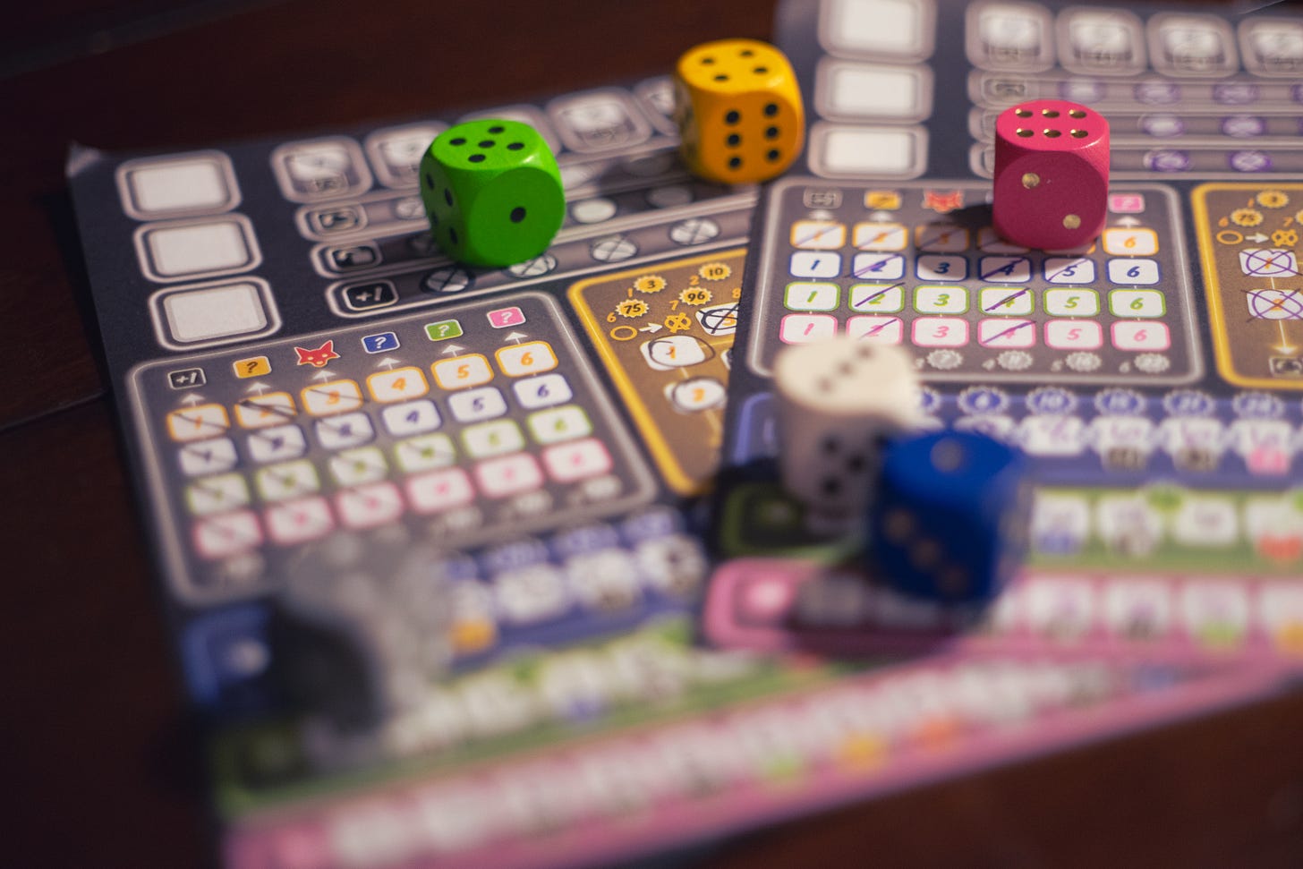 Dice atop two player sheets from the game Ganz Schön Clever.