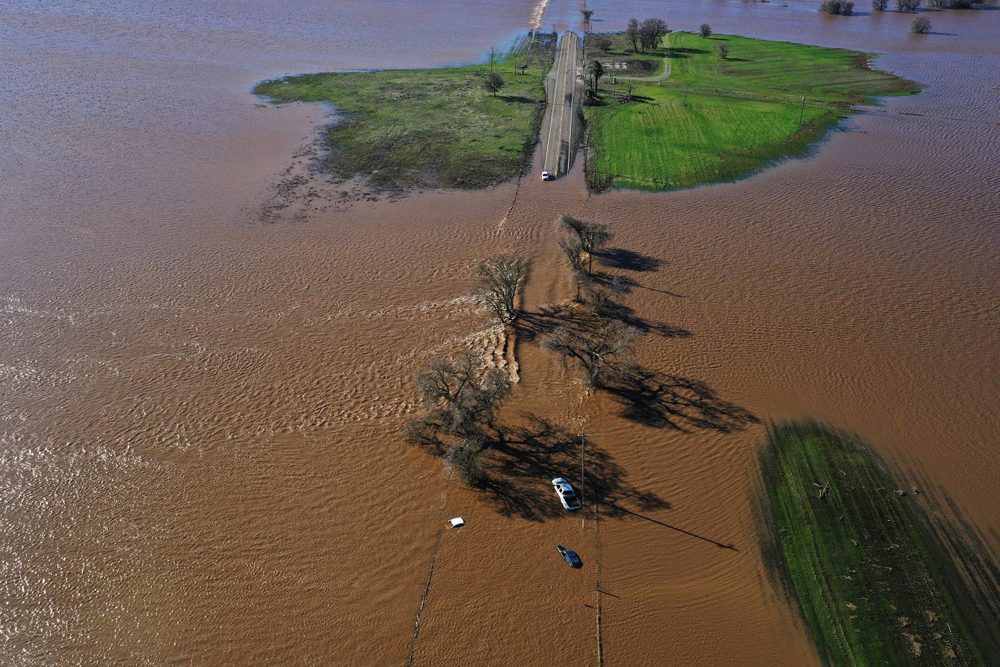 Three vehicles are submerged on Dillard Road west of Highway 99 in south Sacramento County in Wilton, Calif., on Sunday after heavy rains on New Year's Eve produced levee breaks.