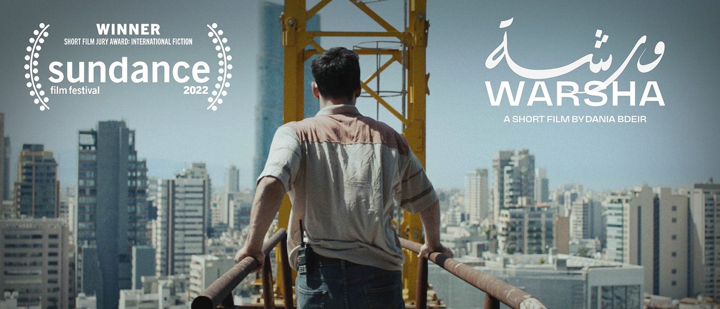 A man walks away from the camera on the bridge of a construction crane, with skyscrapers in the city in front of him. Text overlaid on the image says “Warsha: A short film by Dania Bdeir”, and also includes a laurel from the 2022 Sundance Film Festival for winning the short film jury award for international fiction.