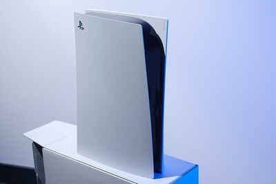 On the left, The Onion's depiction of the Ghost of Christmas Future holding out a PS5 in front of children. On the right, the actual PlayStation 5.