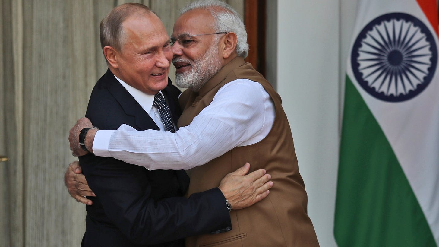 FILE - Indian Prime Minister Narendra Modi hugs Russian President Vladimir Putin before their meeting in New Delhi, India, Oct. 5, 2018. Putin will participate on Tuesday, July 4, 2023, for a summit of the Shanghai Cooperation Organization, a security grouping founded by Russia and China to counter Western alliances from East Asia to the Indian Ocean. This year’s event is hosted by India, which became a member in 2017. It's the latest avenue for Modi to showcase the country’s growing global clout. (AP Photo/Manish Swarup, File)