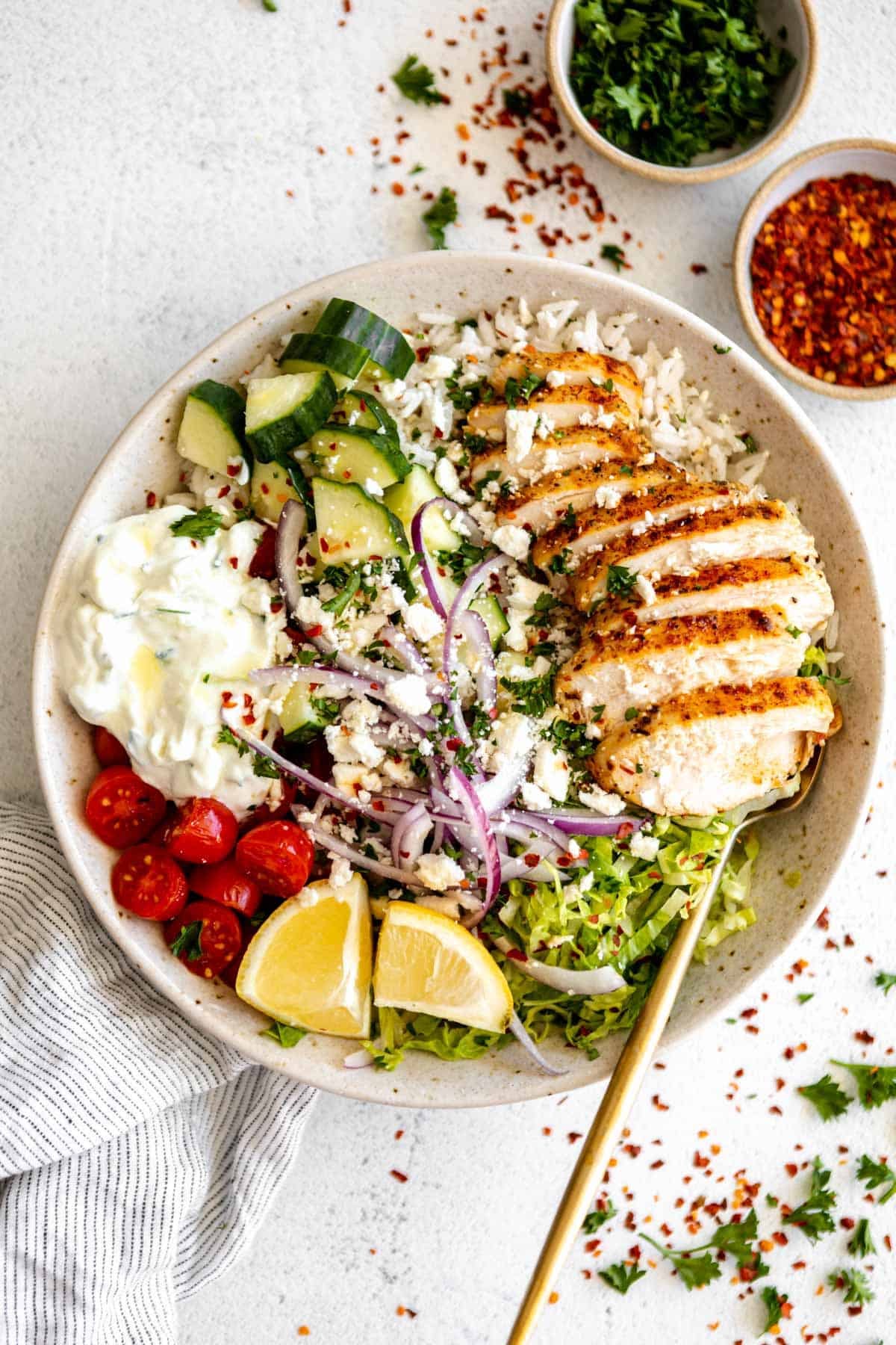 greek chicken bowls with veggies, onion and lemon herb chicken