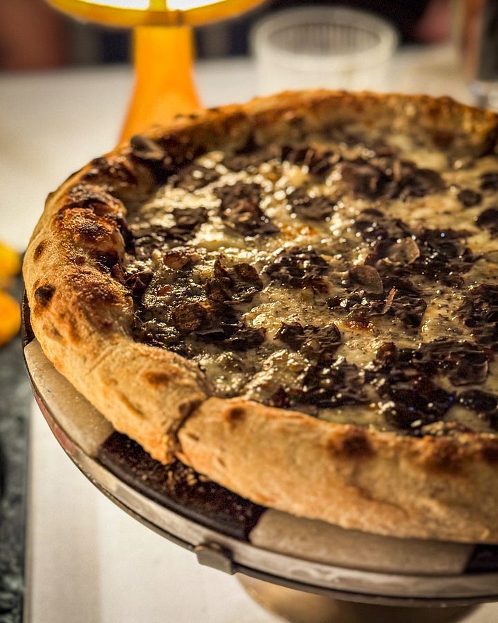A selection of dishes from Loren: Truffle Pizza, Woodfire Grilled Ribeye Steak and a pear cheesecake with a dark chocolate souffle.