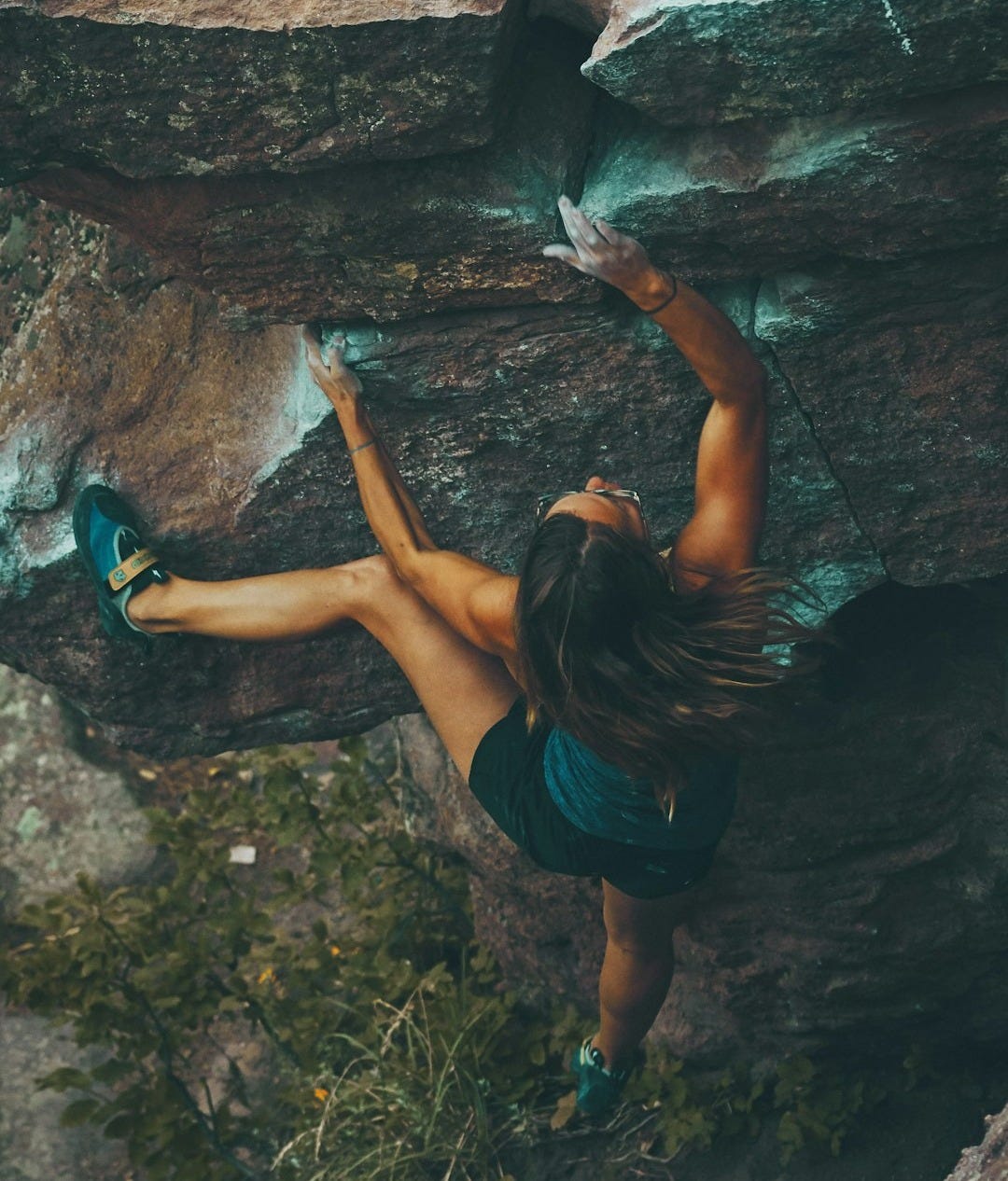 photo of woman climbing mountain