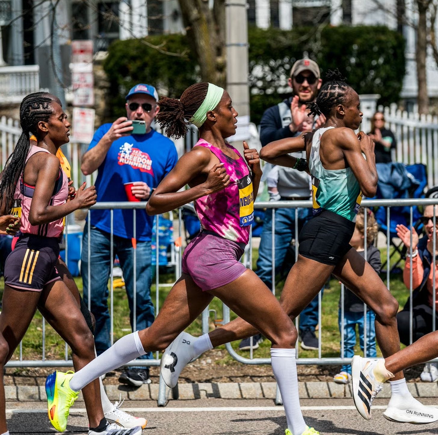 Female marathon runners competing during a road race. Female marathon runners competing during a road race.