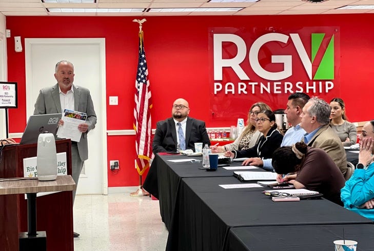 A person standing at a podium with a group of people sitting at a tableAI-generated content may be incorrect.