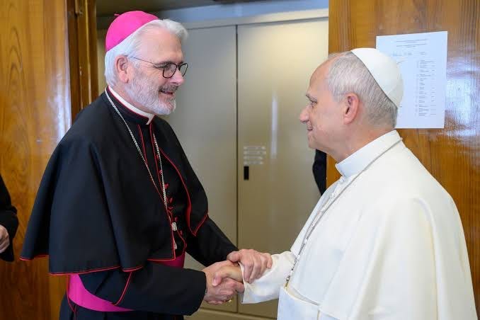 Pope Leo XIV shakes hands with Archbishop Paul Coakley