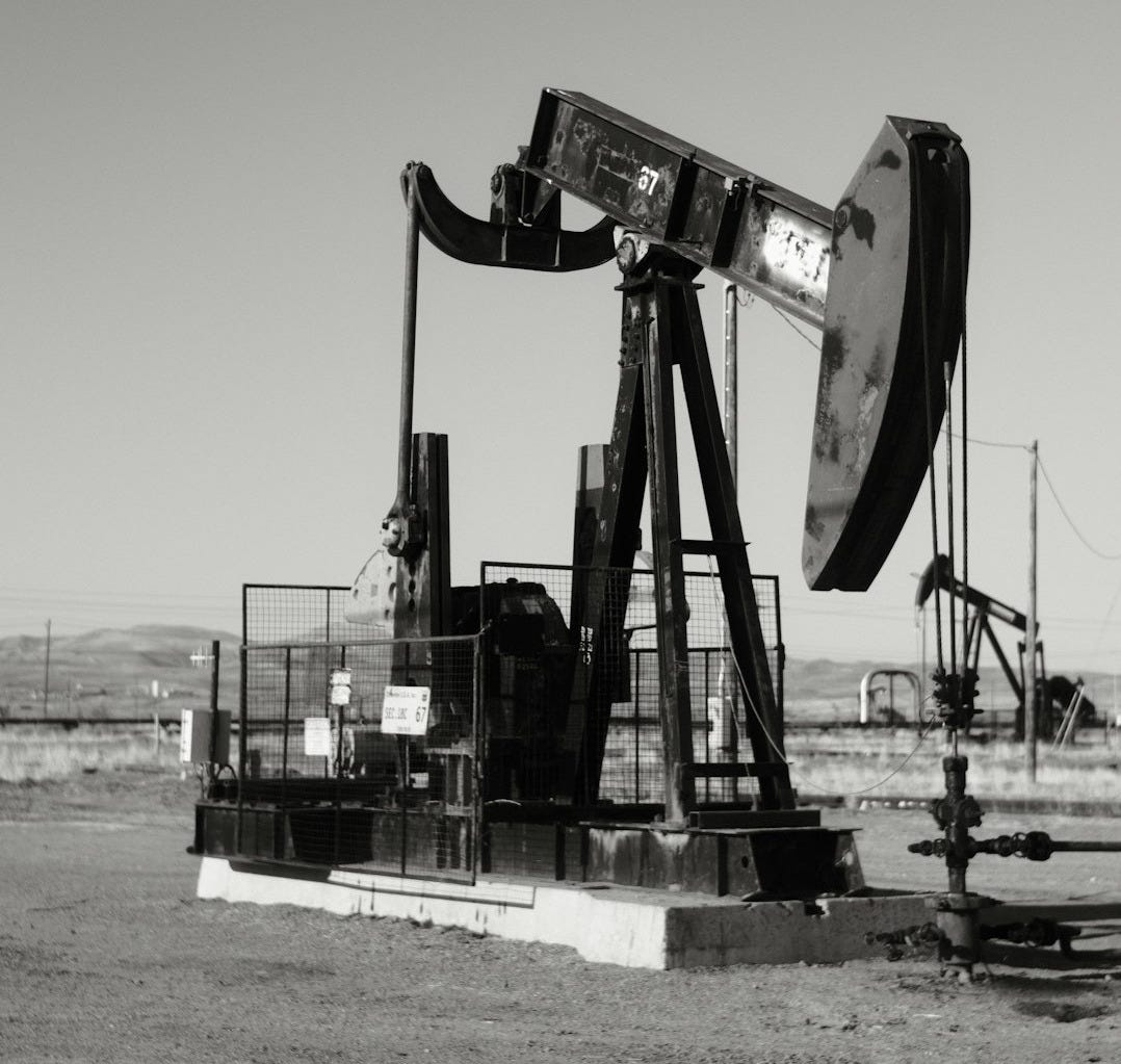 a black and white photo of an oil pump a black and white photo of an oil pump
