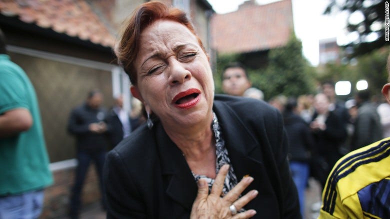 An opponent to the peace deal signed celebrates after she listened to the results of the referendum. An opponent to the peace deal signed celebrates after she listened to the results of the referendum.