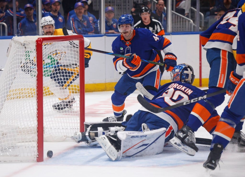 New York Islanders' Jean-Gabriel Pageau (44) and Ilya Sorokin (30) watch as a goal is scored by a Nashville Predators player.