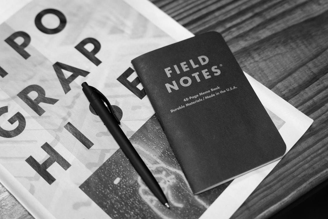 a book and a pen sitting on top of a table a book and a pen sitting on top of a table
