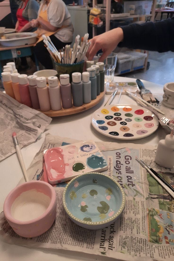 This may contain: the table is covered with art supplies and paints