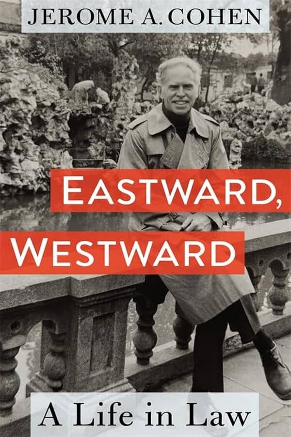 A book cover with a black-and-white photo of Mr. Cohen, wearing a trench coat and sitting on a railing. The name of the book appears over his photo in white uppercase letters on two red rectangles. A book cover with a black-and-white photo of Mr. Cohen, wearing a trench coat and sitting on a railing. The name of the book appears over his photo in white uppercase letters on two red rectangles.
