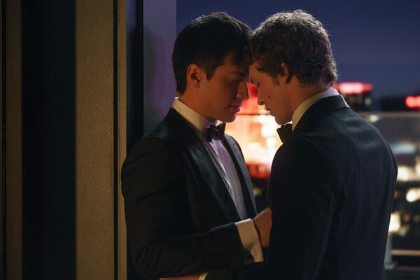 Wearing tuxedos, Hudson Williams and Connor Storrie embrace each other with their foreheads touching. Wearing tuxedos, Hudson Williams and Connor Storrie embrace each other with their foreheads touching.