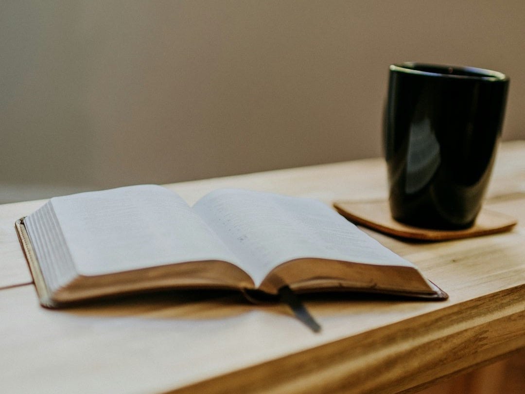 a book and a cup on a table a book and a cup on a table