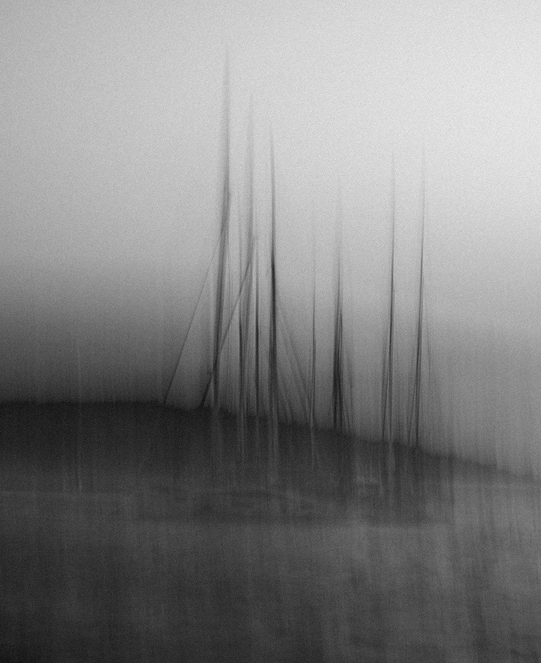 a black and white photo of a boat in the water