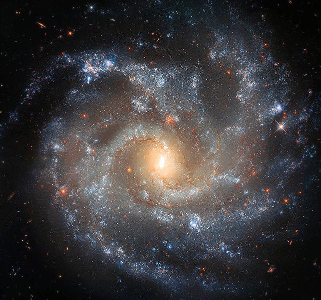 Spiral galaxy NGC 5584 captured by the Hubble Space Telescope, showcasing its well-defined spiral arms filled with young blue stars, star-forming regions, and interstellar dust Spiral galaxy NGC 5584 captured by the Hubble Space Telescope, showcasing its well-defined spiral arms filled with young blue stars, star-forming regions, and interstellar dust