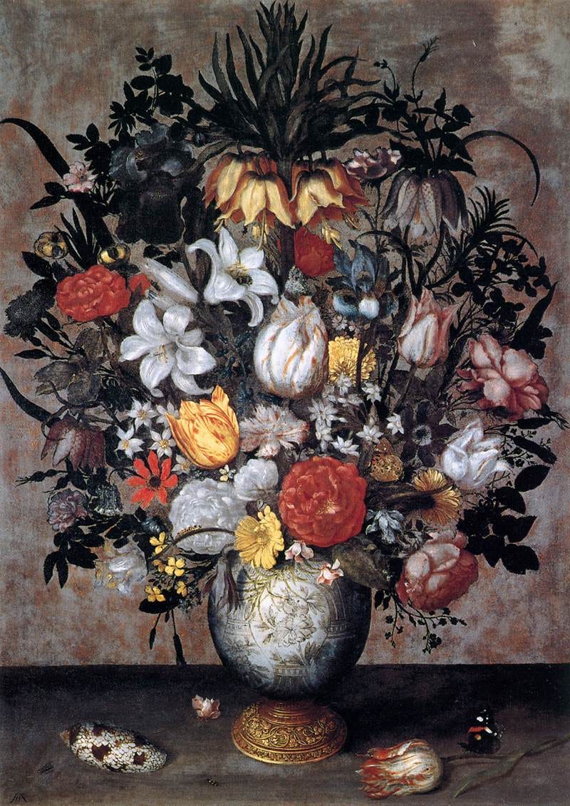 A tight symmetrical bouquet in a glass vase with a single butterfly on a leaf A tight symmetrical bouquet in a glass vase with a single butterfly on a leaf