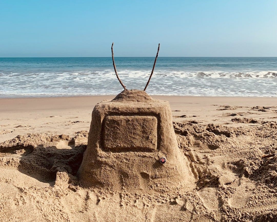 a sand castle on a beach a sand castle on a beach