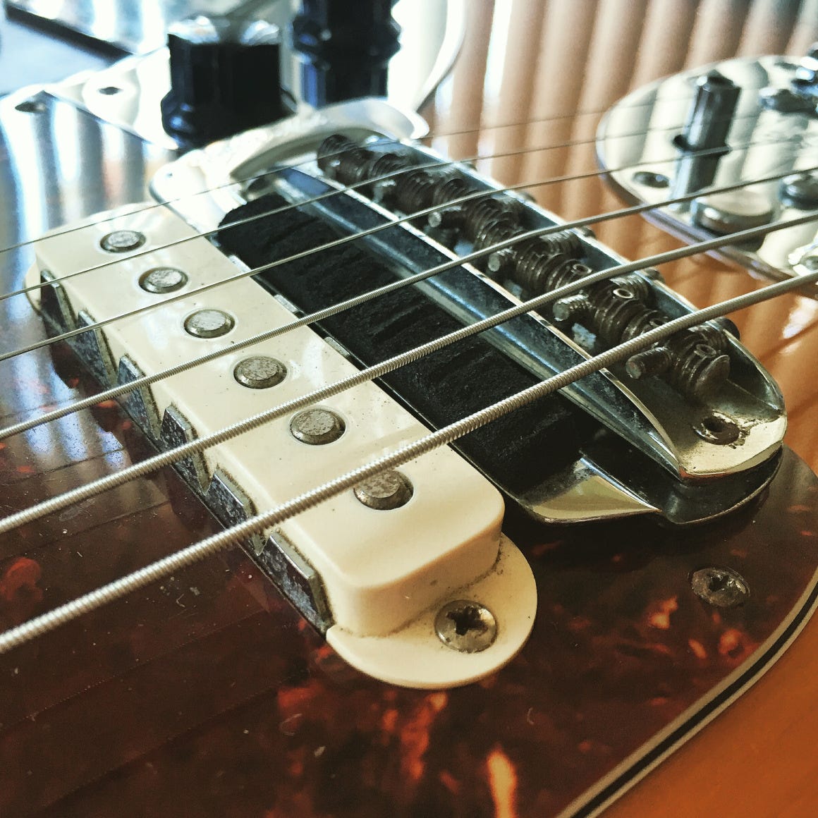 A close-up of a guitar with a pickup, capturing the intricate details of the instrument's design.