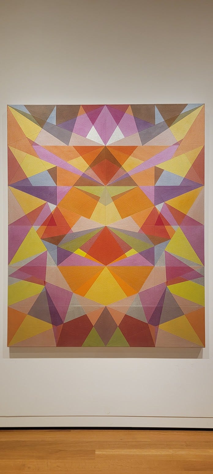 An acrylic painting of colorful geometries overlapping and merging.