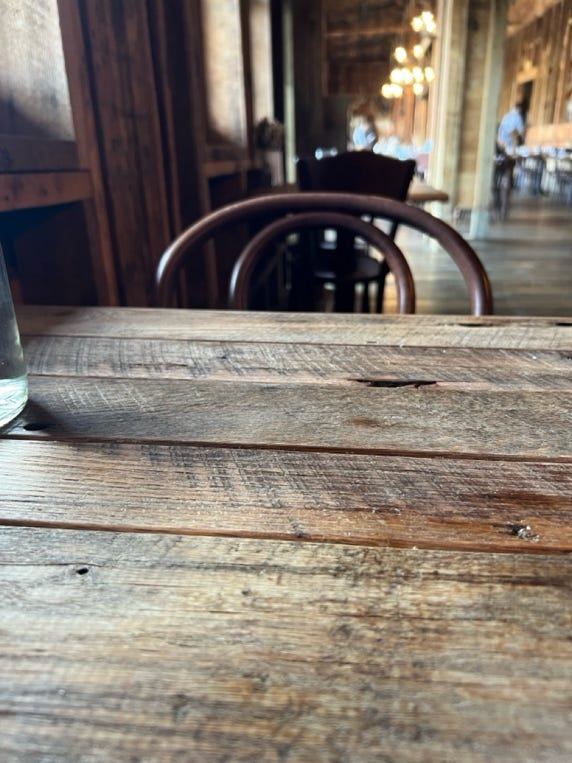A wooden table with a glass on it

AI-generated content may be incorrect.