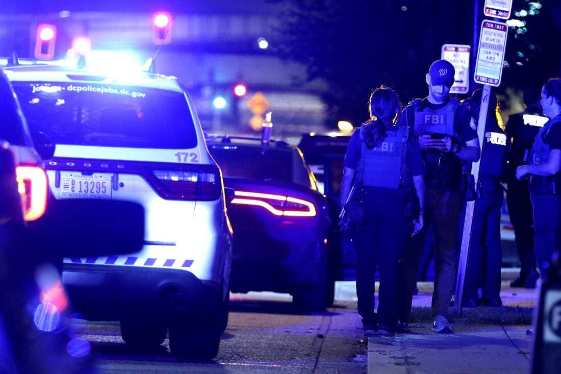 Federal and local law enforcement officers investigate a suspect’s vehicle on South Capitol Street on August 11 in Washington, D.C.