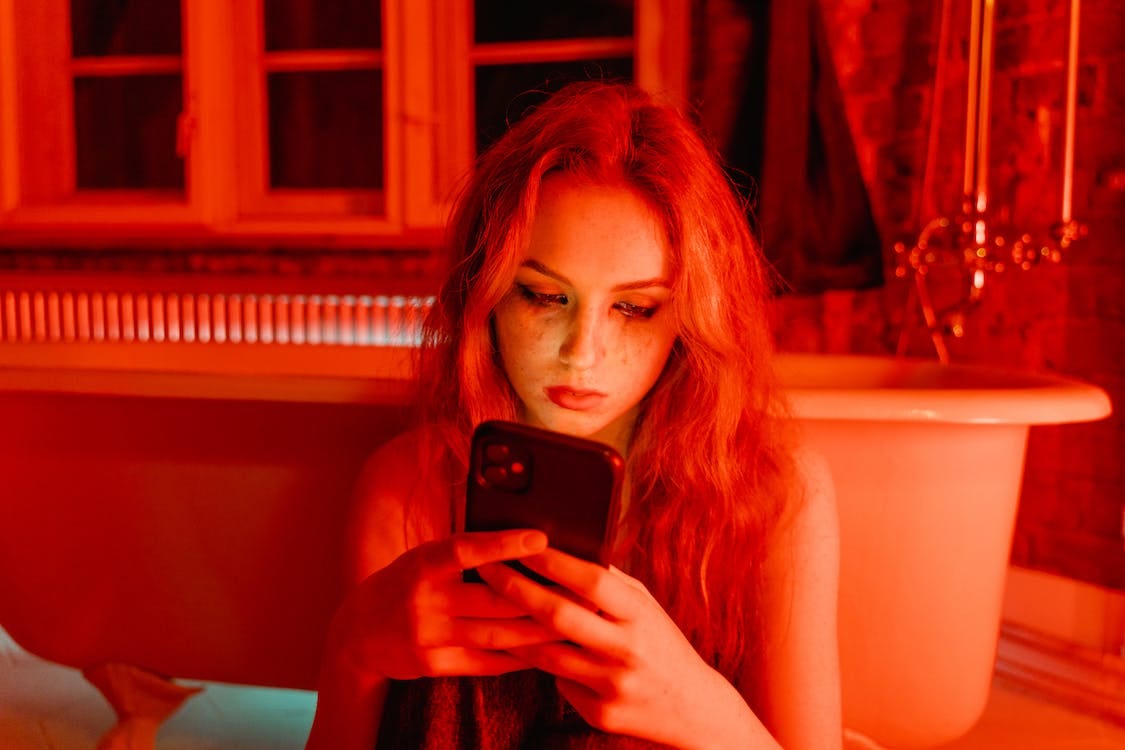Free Woman with Smudge on Face Holding Cellphone Stock Photo