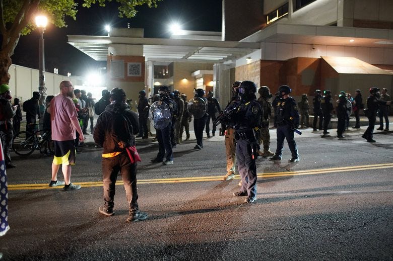 People protest outside the Portland ICE facility Saturday after President Donald Trump announced that he will send troops to Portland. (Samantha Swindler / The Oregonian via AP)