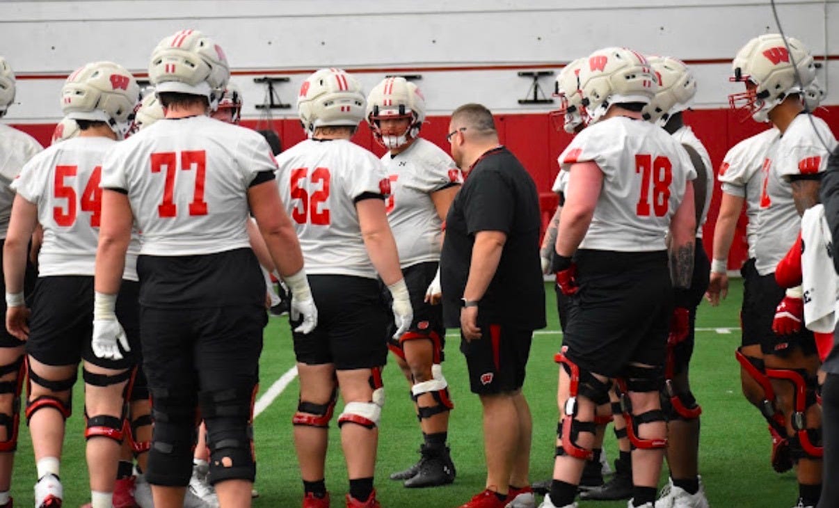 Wisconsin Badgers offensive line coach Eric Mateos on the field with the offensive line during practice. Wisconsin Badgers offensive line coach Eric Mateos on the field with the offensive line during practice.